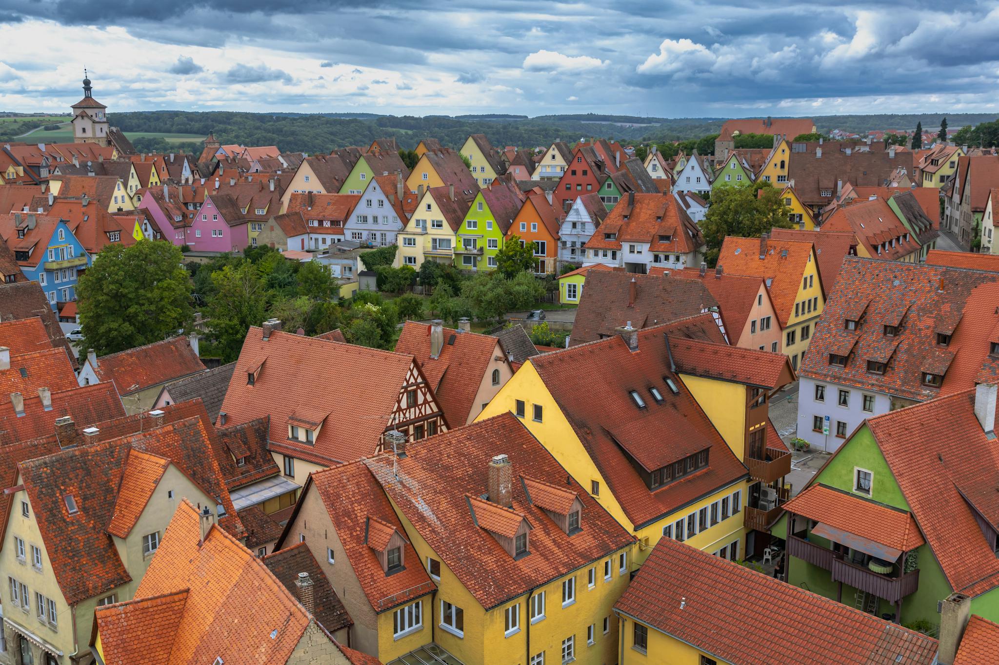 Aerial view of Rothenburg, Germany showcasing colorful houses and medieval architecture under dramatic skies.
