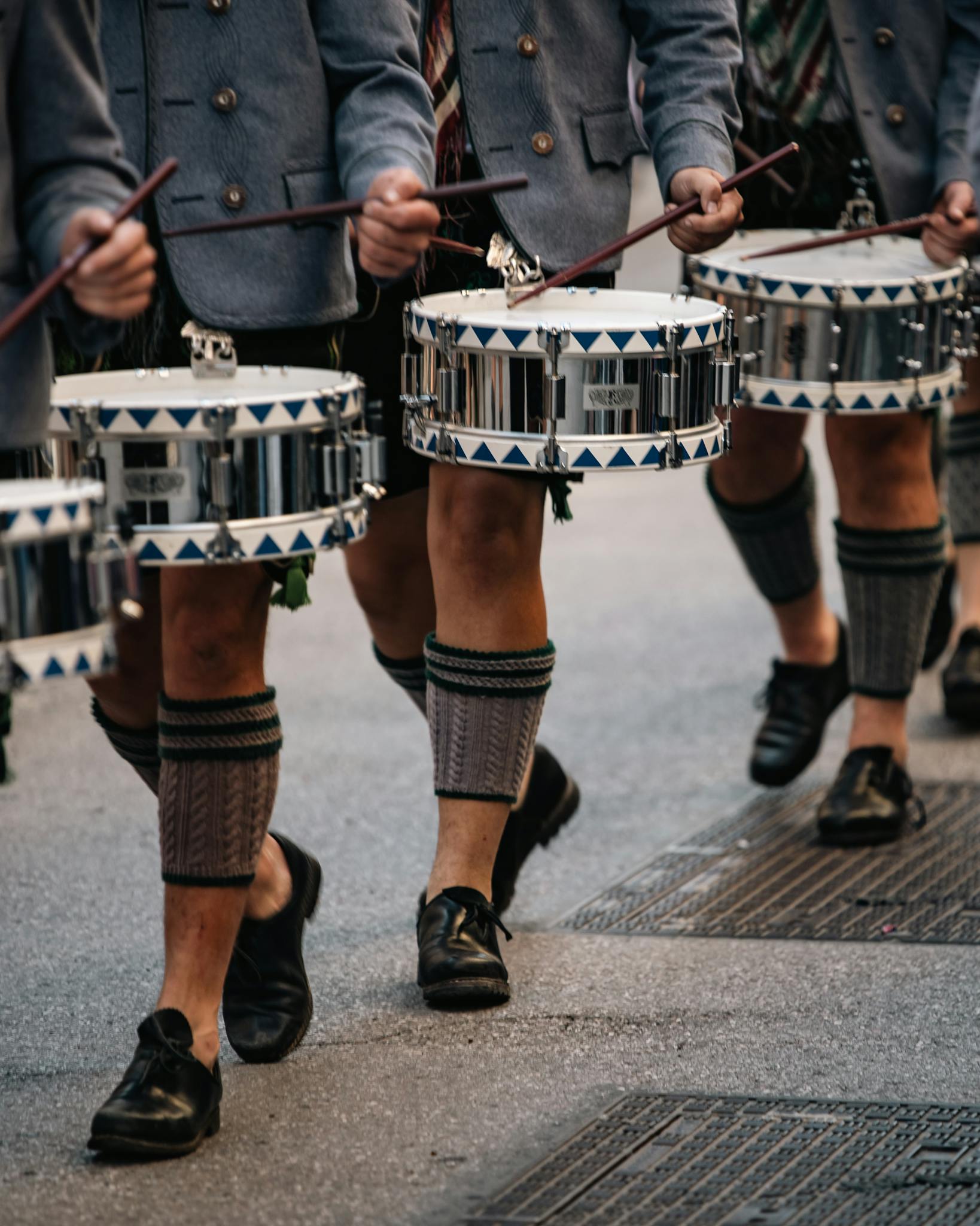 Traditional German drummers in lederhosen and jackets perform in a lively parade in Munich, Germany.
